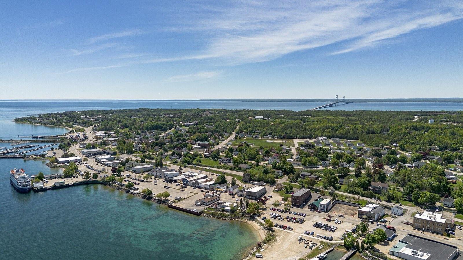 Aerial view of St. Ignace, Michigan: the harbor, downtown, and the Mackinac Bridge on the horizon
