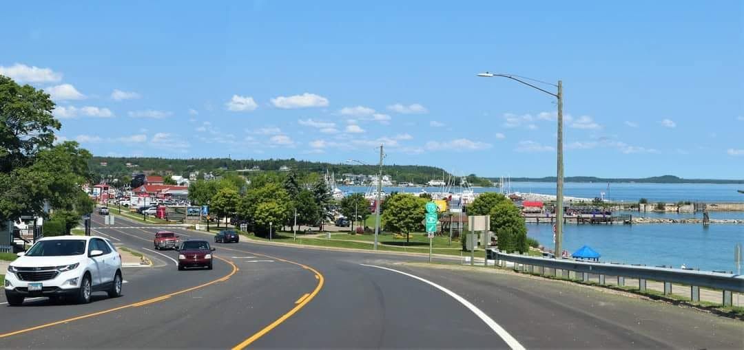 US-2 curving into downtown St. Ignace, the marina and Lake Huron on the right